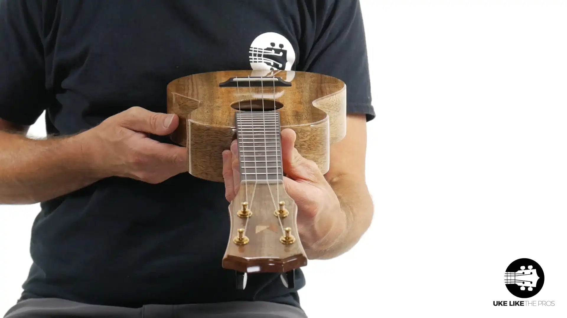 Rebel ukulele with natural wood finish displayed at Terry Carter Music Store, close-up front view.