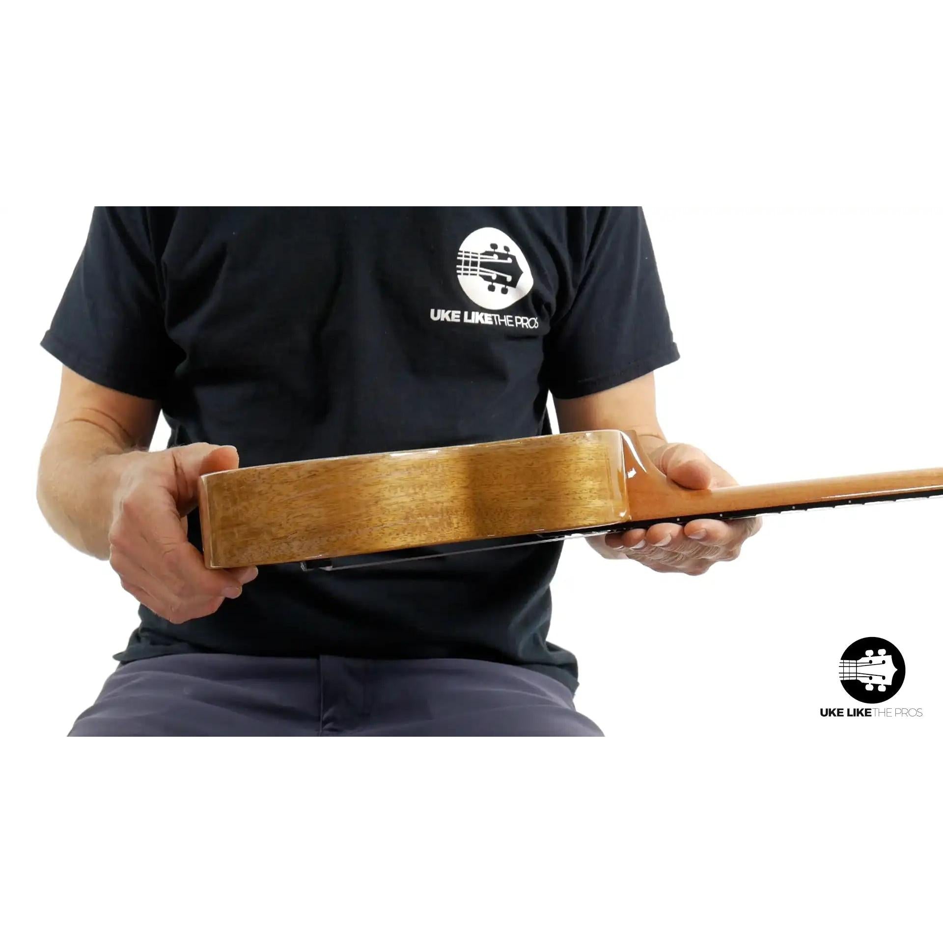 Side view of Rebel Double Creme Concert ukulele with natural wood grain at Terry Carter Music Store