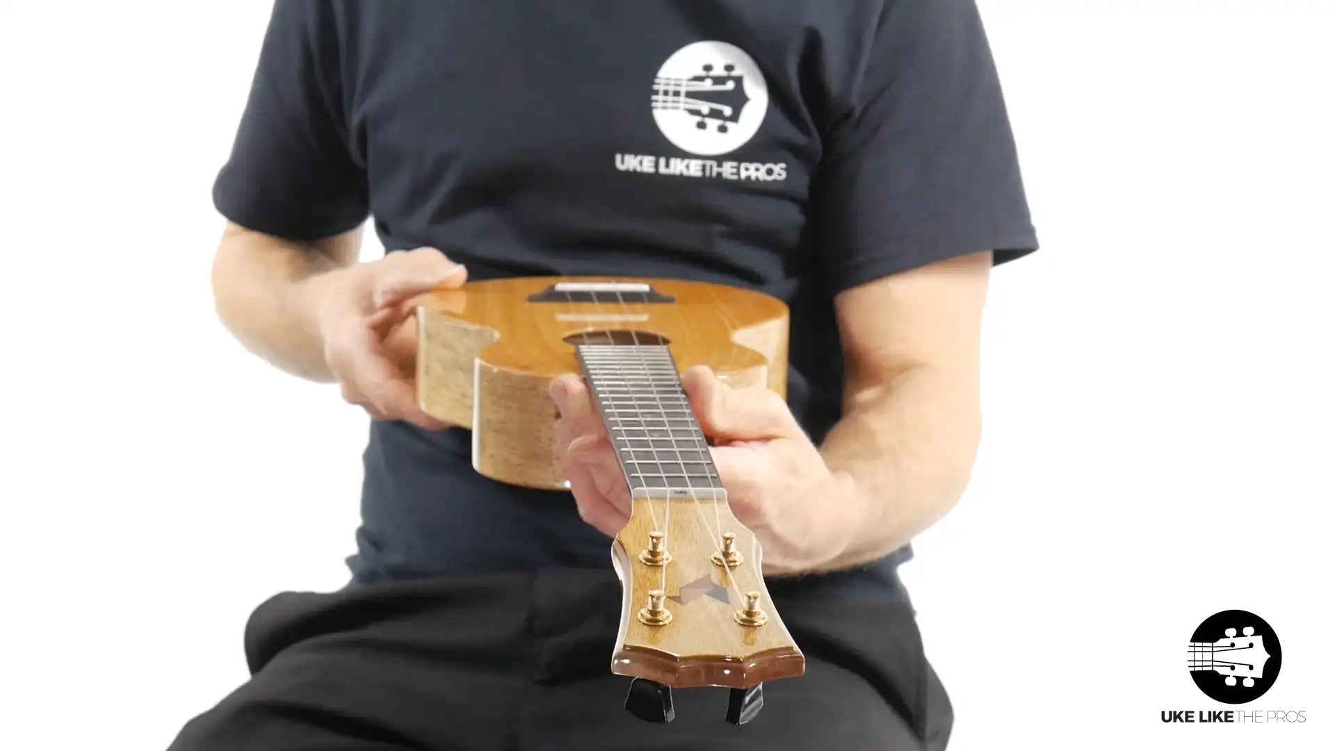 Rebel Double Creme Mango Magic ukulele with mango wood top, held in hand, at Terry Carter Music Store