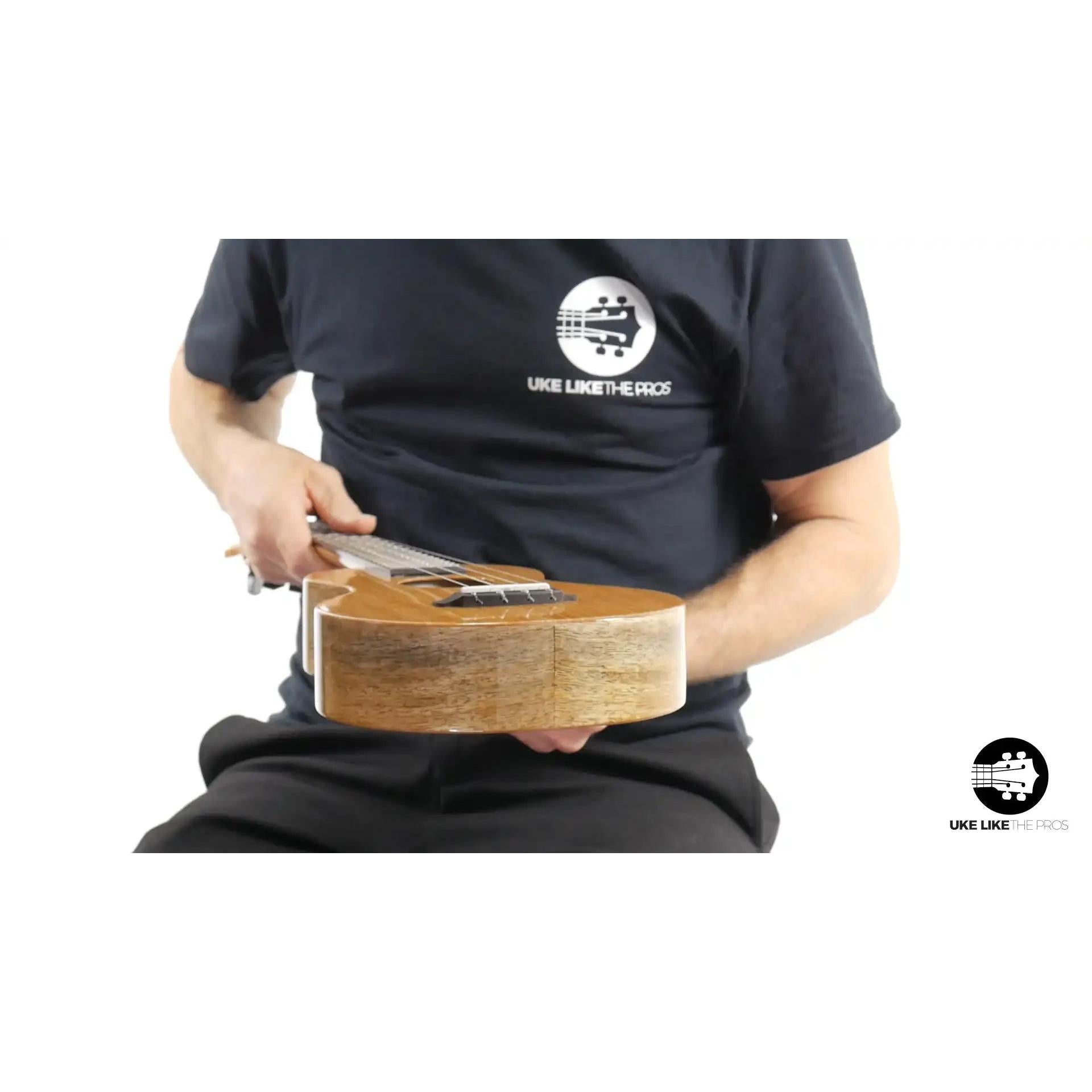 Person holding wood Rebel Double Creme ukulele, Mango Magic finish, Terry Carter Music Store
