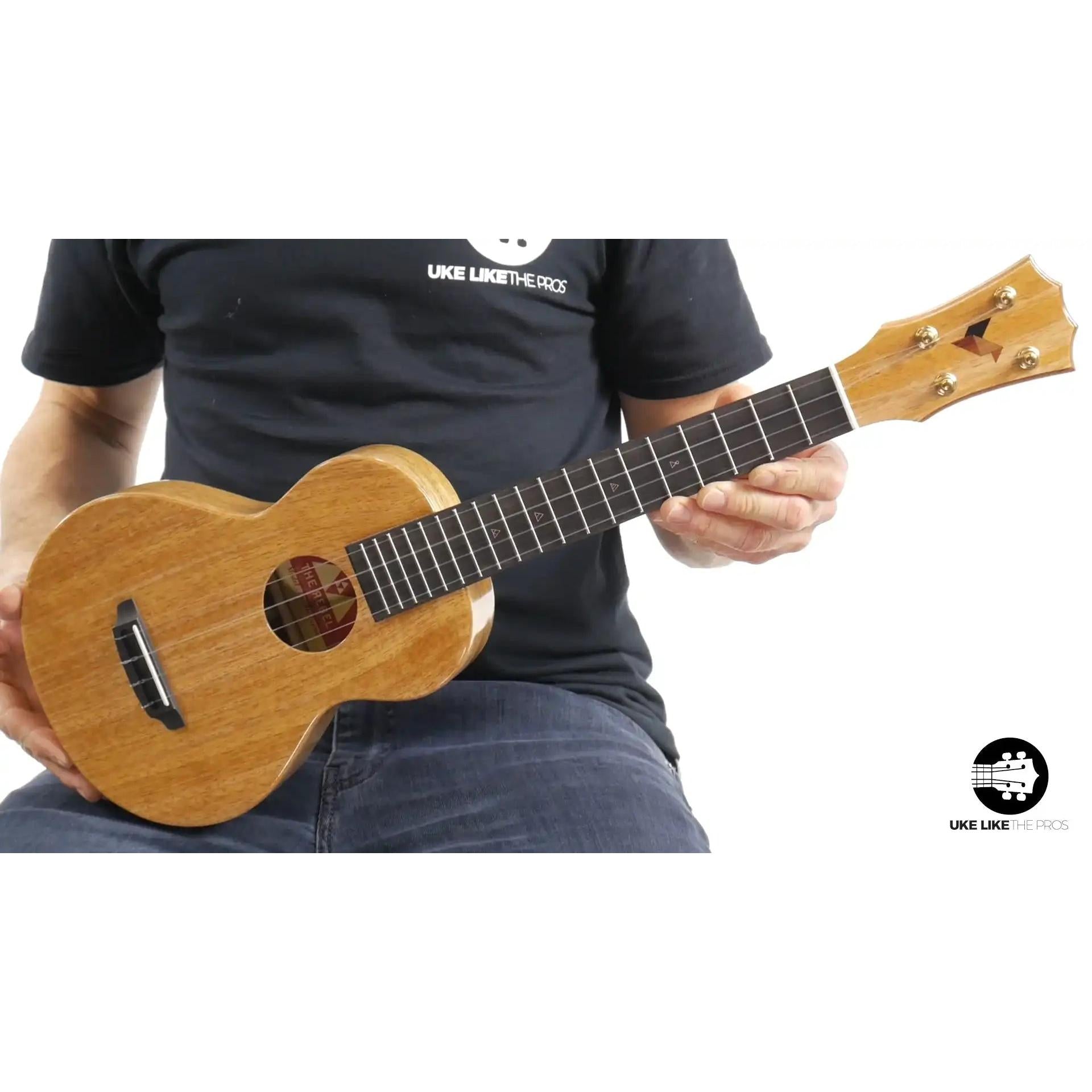 Rebel Double Creme ukulele mahogany wood held by person, Terry Carter Music Store product