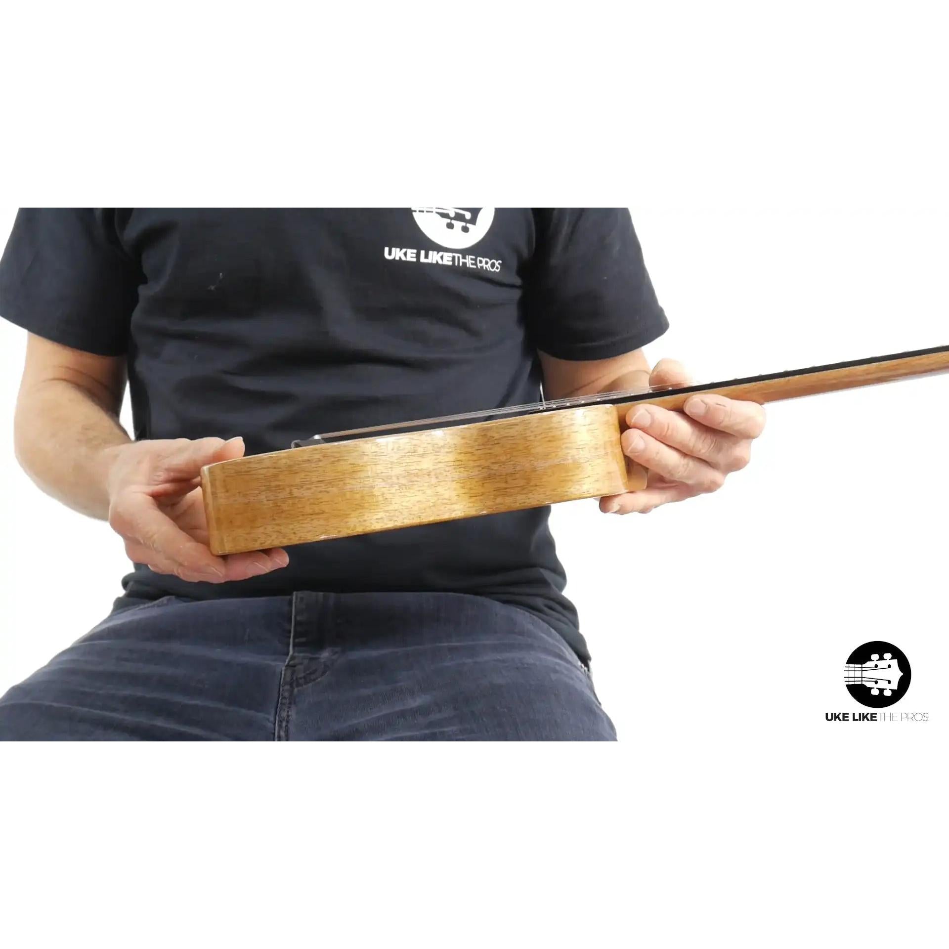 Side view of Rebel Double Creme ukulele with natural wood finish at Terry Carter Music Store.