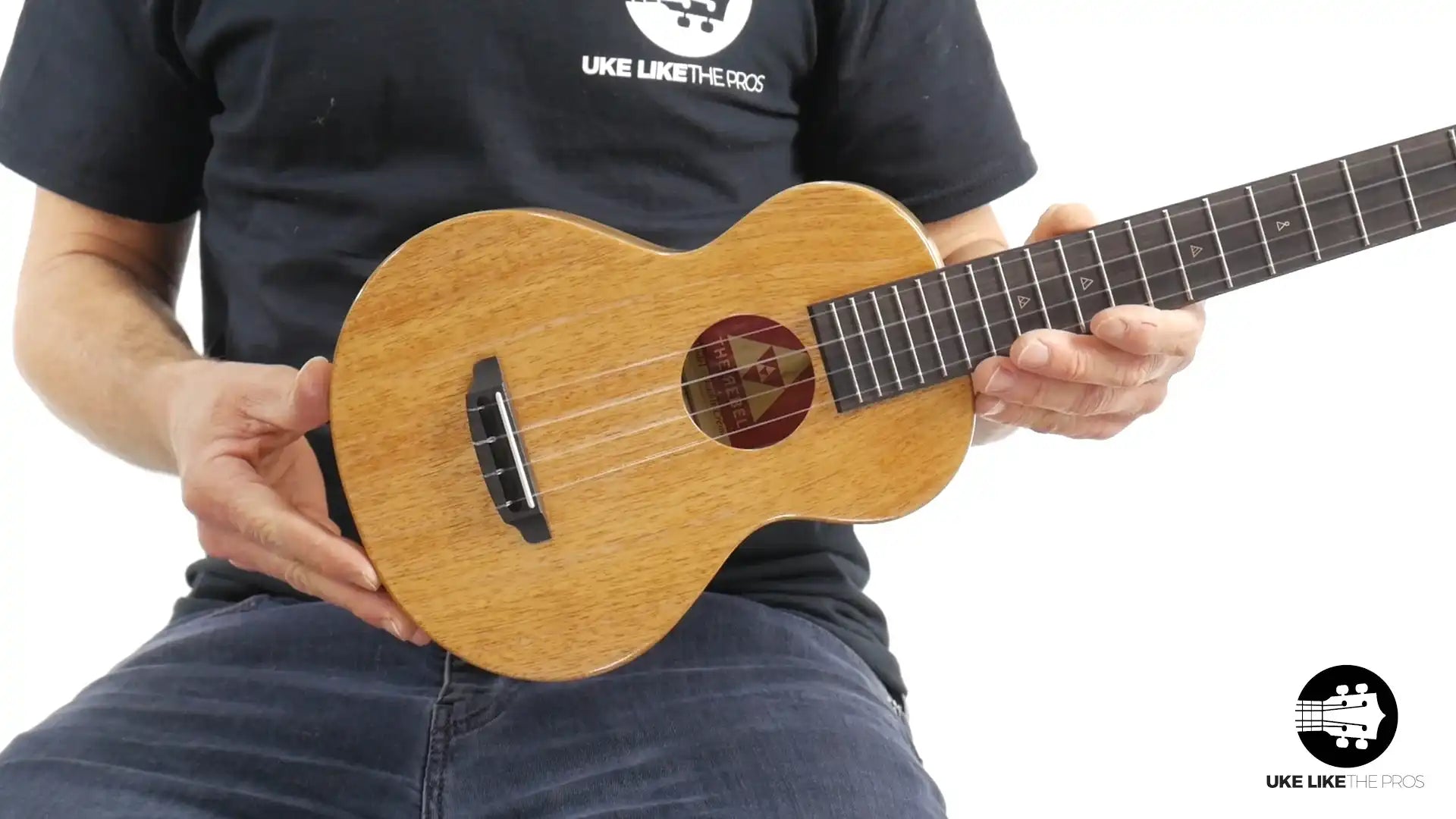 Rebel Double Creme ukulele with natural wood finish held by musician, Terry Carter Music Store