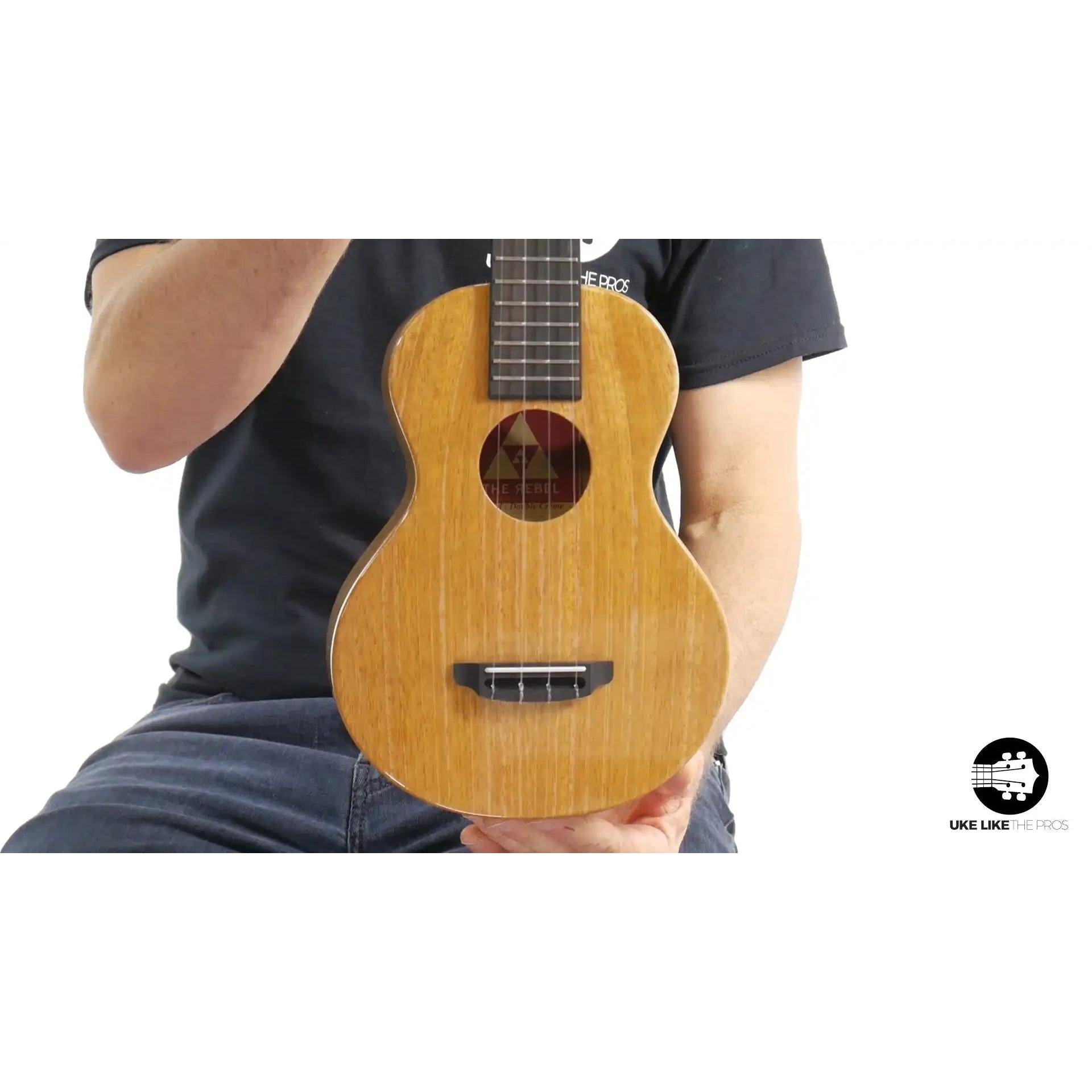 Rebel Double Creme ukulele with natural wood finish held by musician, Terry Carter Music Store