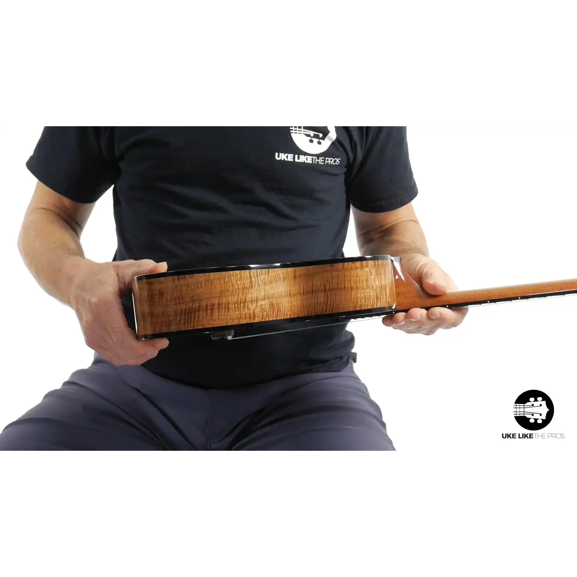 Rebel ukulele with figured wood side, shown in hand, Terry Carter Music Store product image