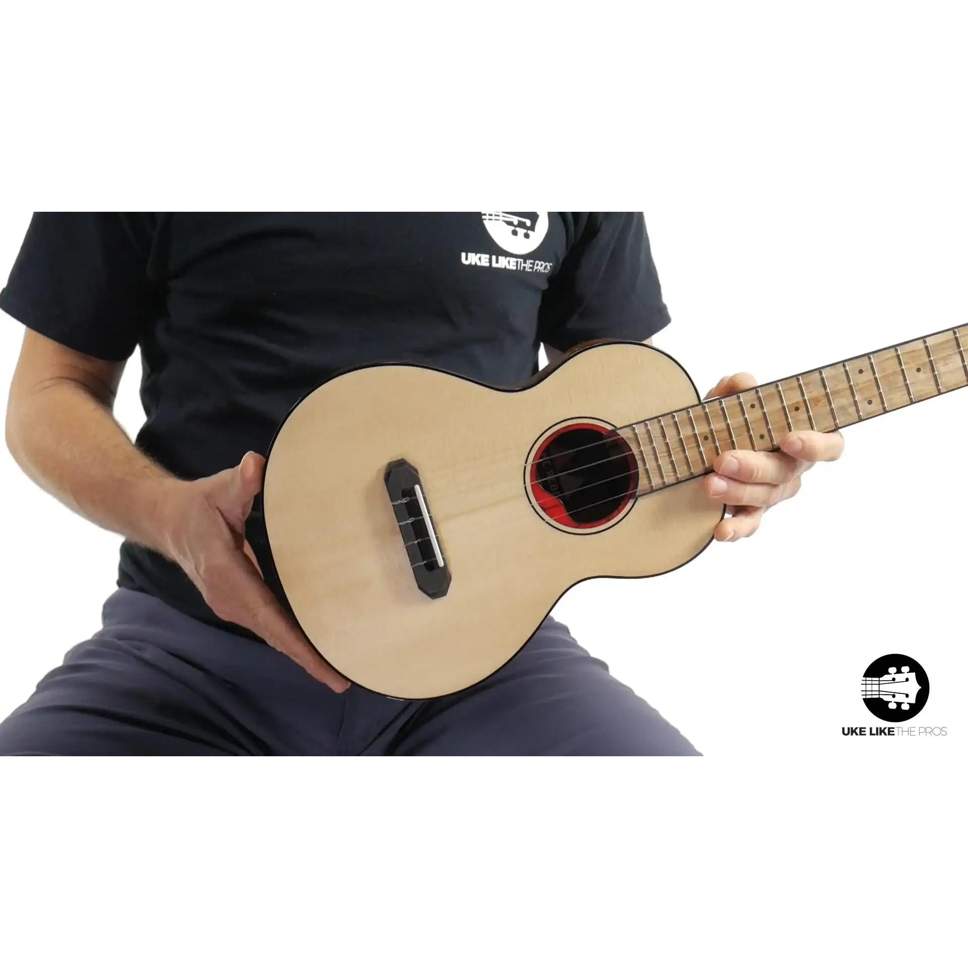 Rebel ukulele with light wood top and red rosette, Terry Carter Music Store.