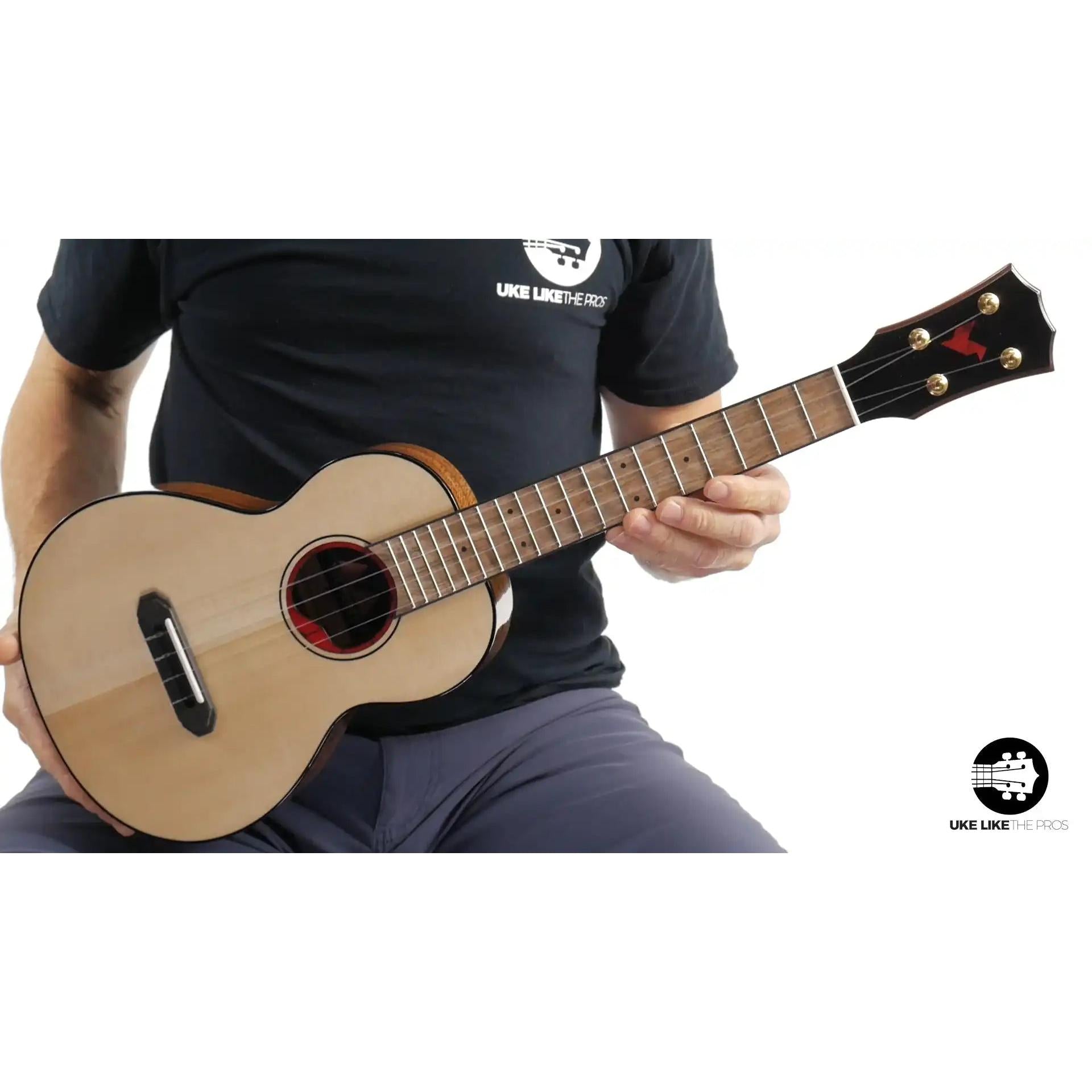 Rebel Pluto Imperial Guard ukulele with natural wood top and red rosette at Terry Carter Music Store