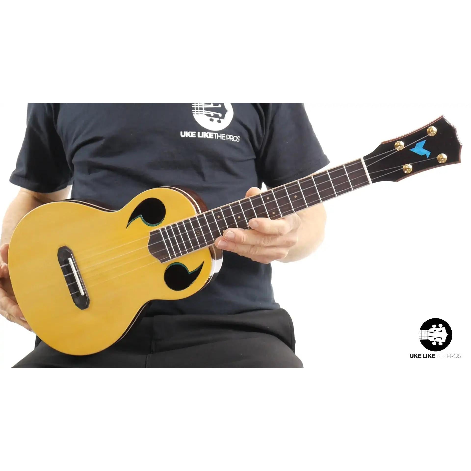 Rebel Quark ukulele with natural wood body and unique sound holes at Terry Carter Music Store.