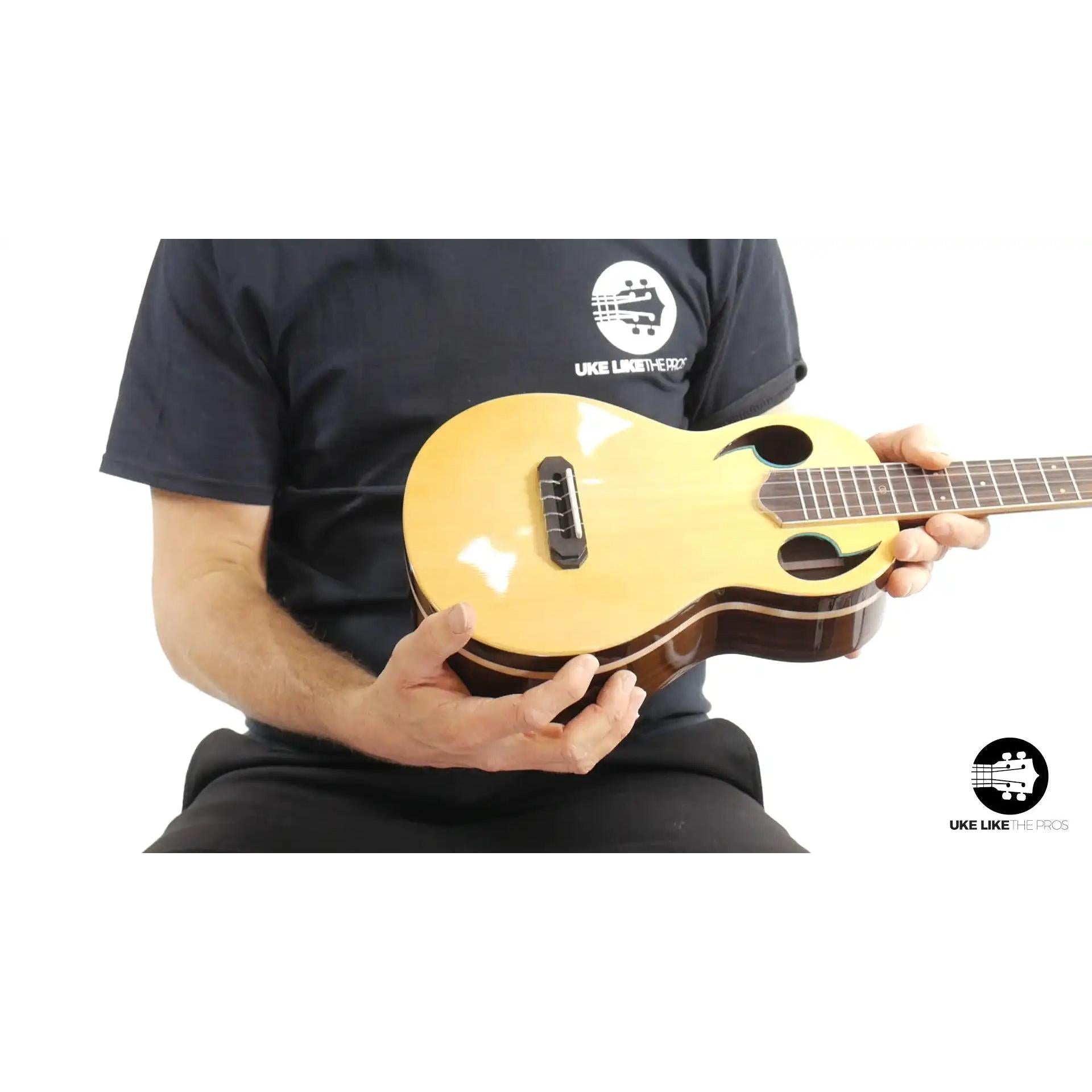 Rebel Quark Hitman B ukulele with light wood top and unique sound holes at Terry Carter Music Store