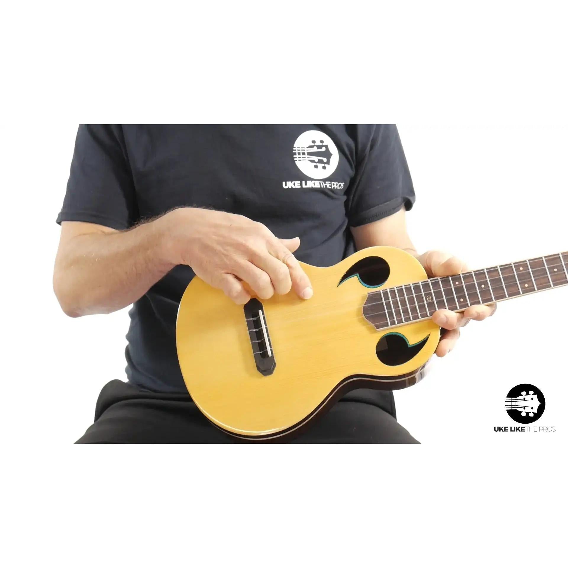 Rebel Quark The Hitman B ukulele with unique sound holes and natural wood body at Terry Carter Music Store.