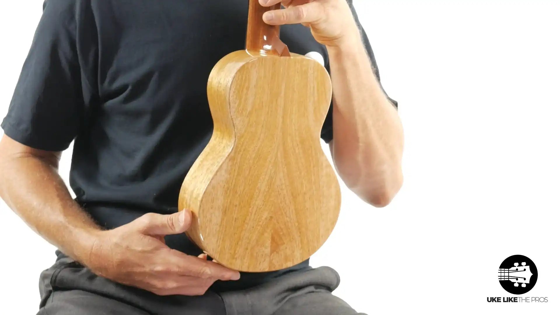 Back view of natural wood ukulele held by person, Terry Carter Music Store product photo