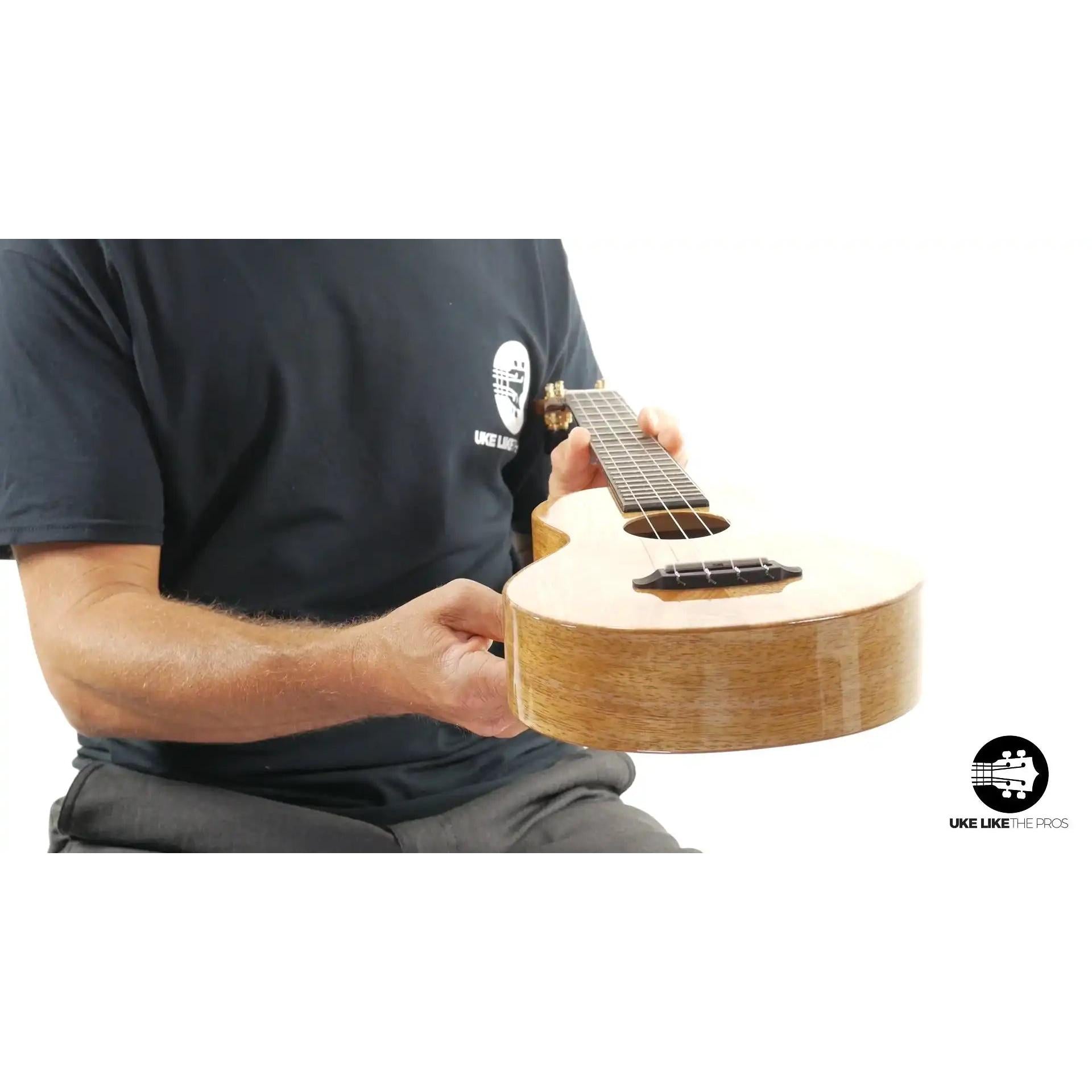 Gloss finished concert ukulele with natural wood grain, featured at Terry Carter Music Store.