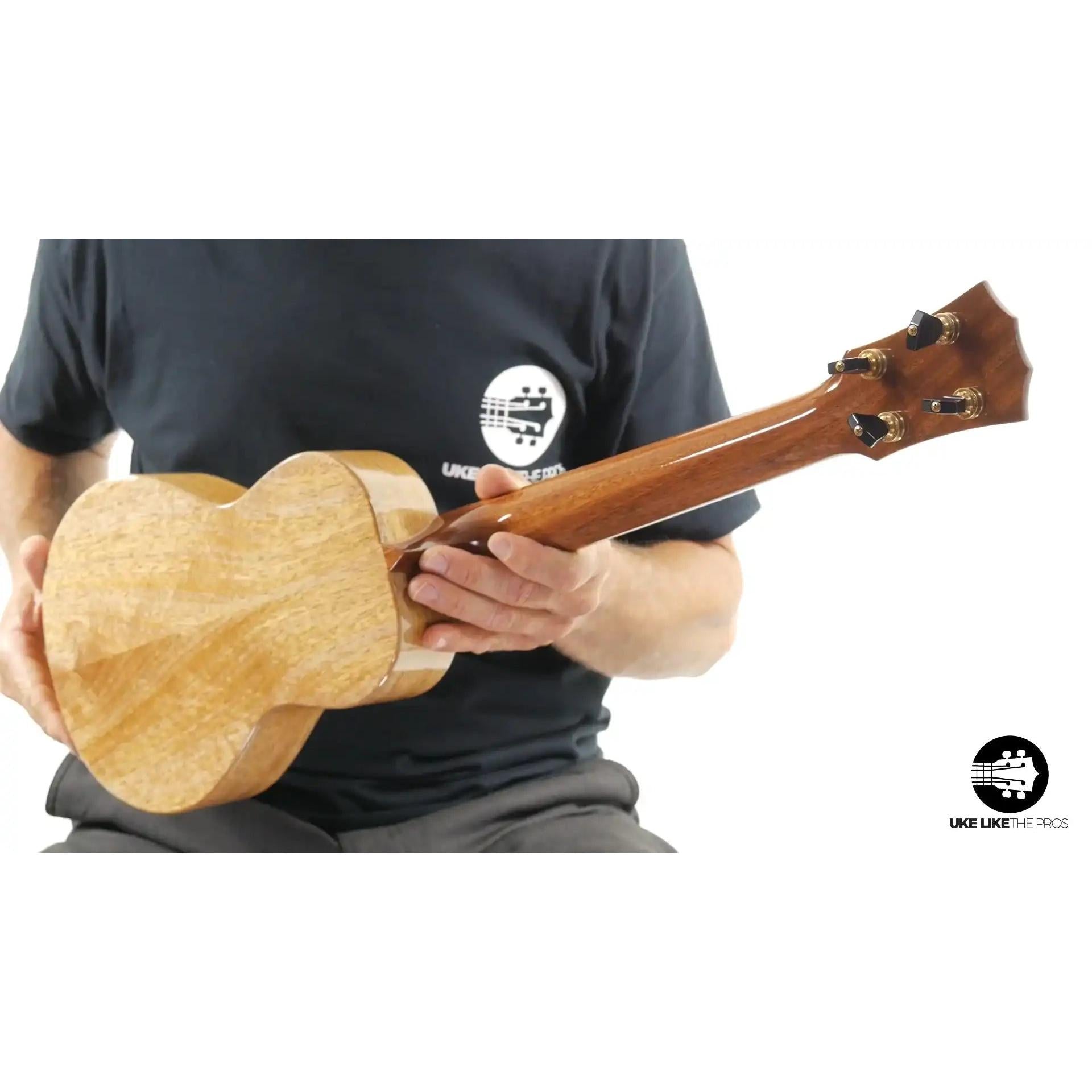 Back of a natural wood ukulele with gloss finish, shown at Terry Carter Music Store