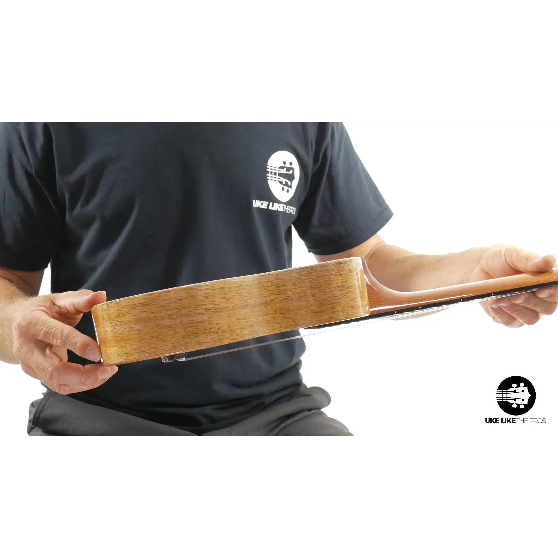 Side view of a natural wood ukulele body, likely mahogany, showcased at Terry Carter Music Store.