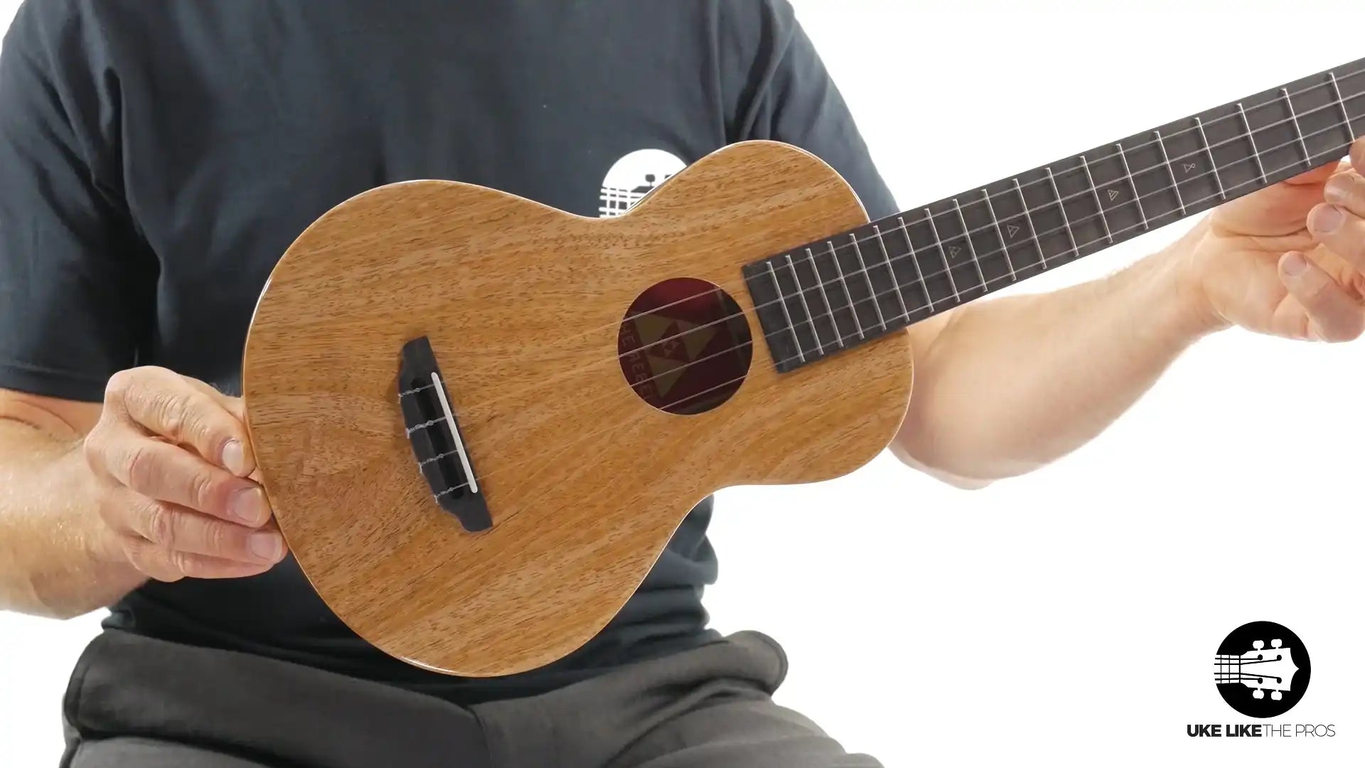 Natural wood soprano ukulele with dark fretboard, showcased at Terry Carter Music Store