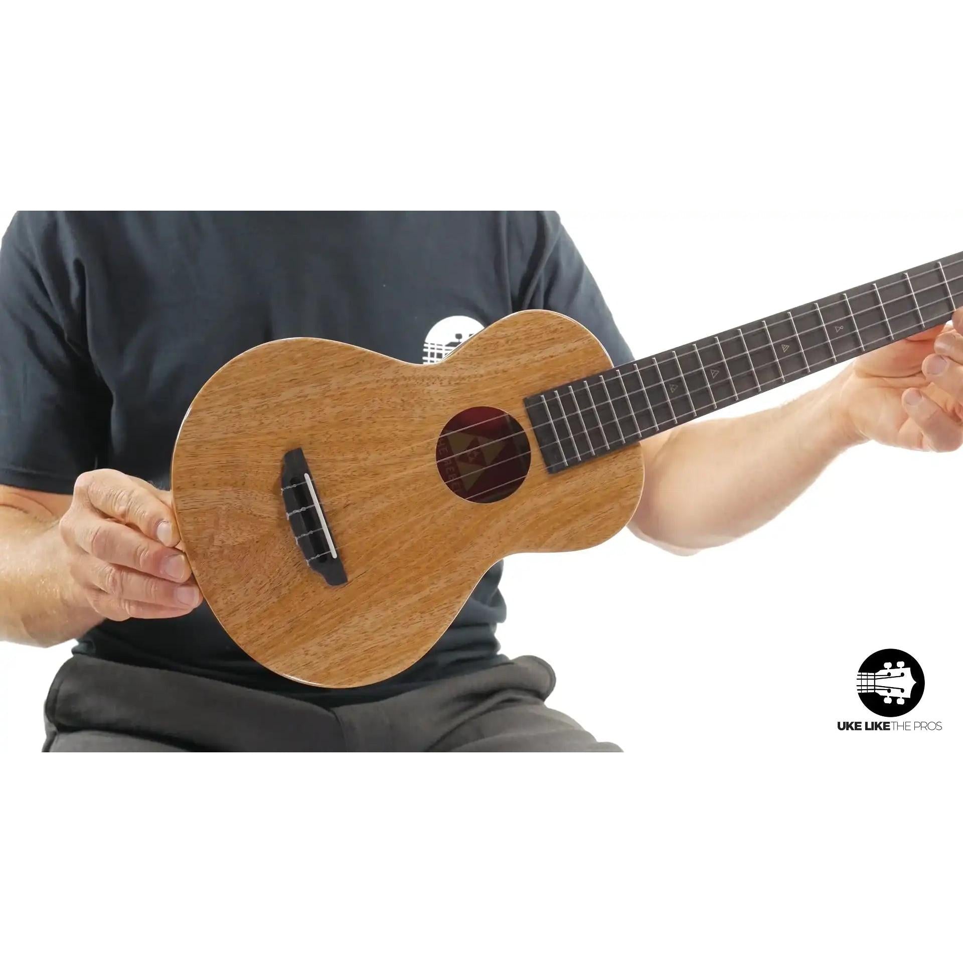 Natural wood soprano ukulele with dark fretboard, showcased at Terry Carter Music Store