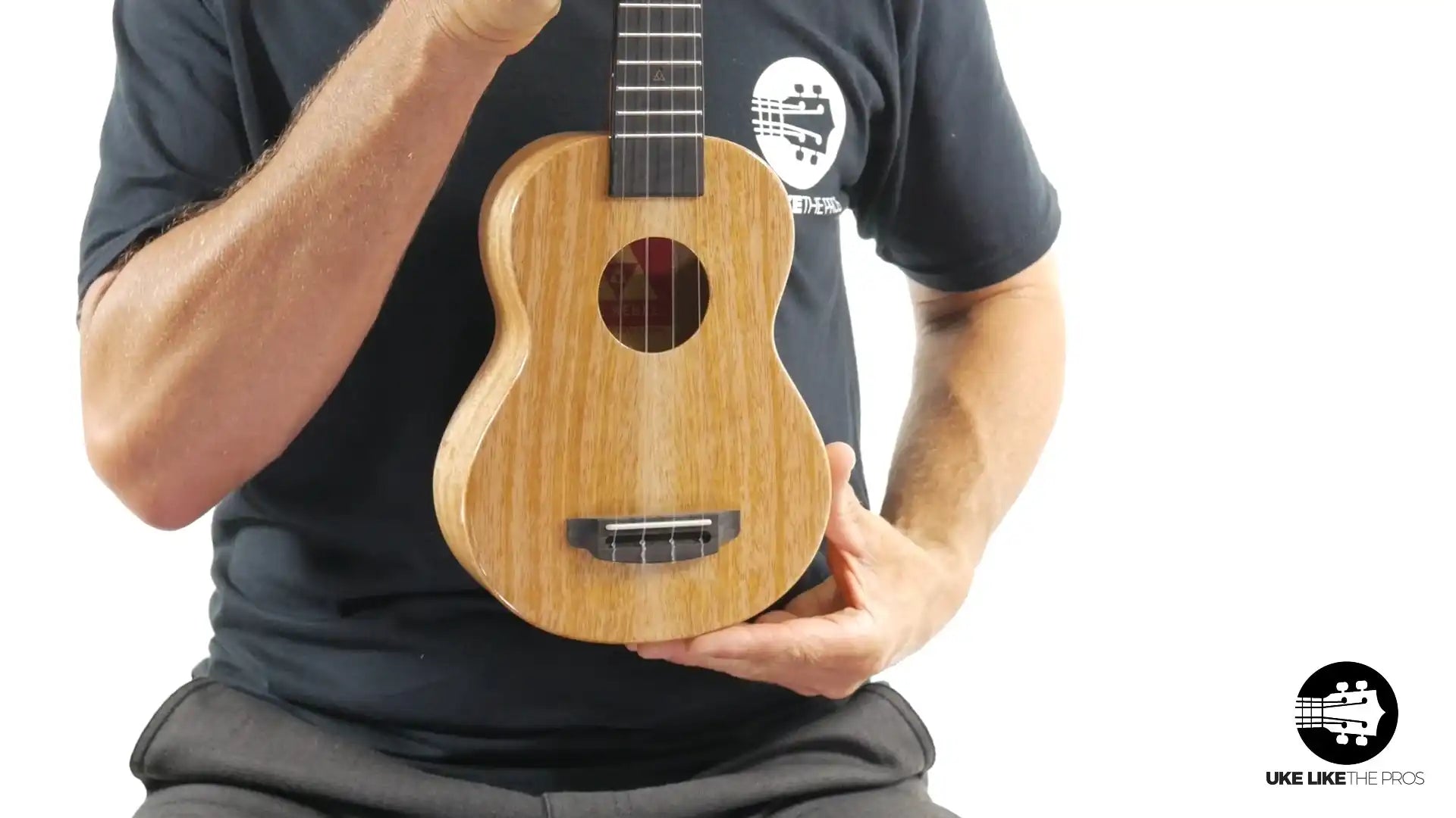Little Giant ukulele with natural wood finish held upright, Terry Carter Music Store
