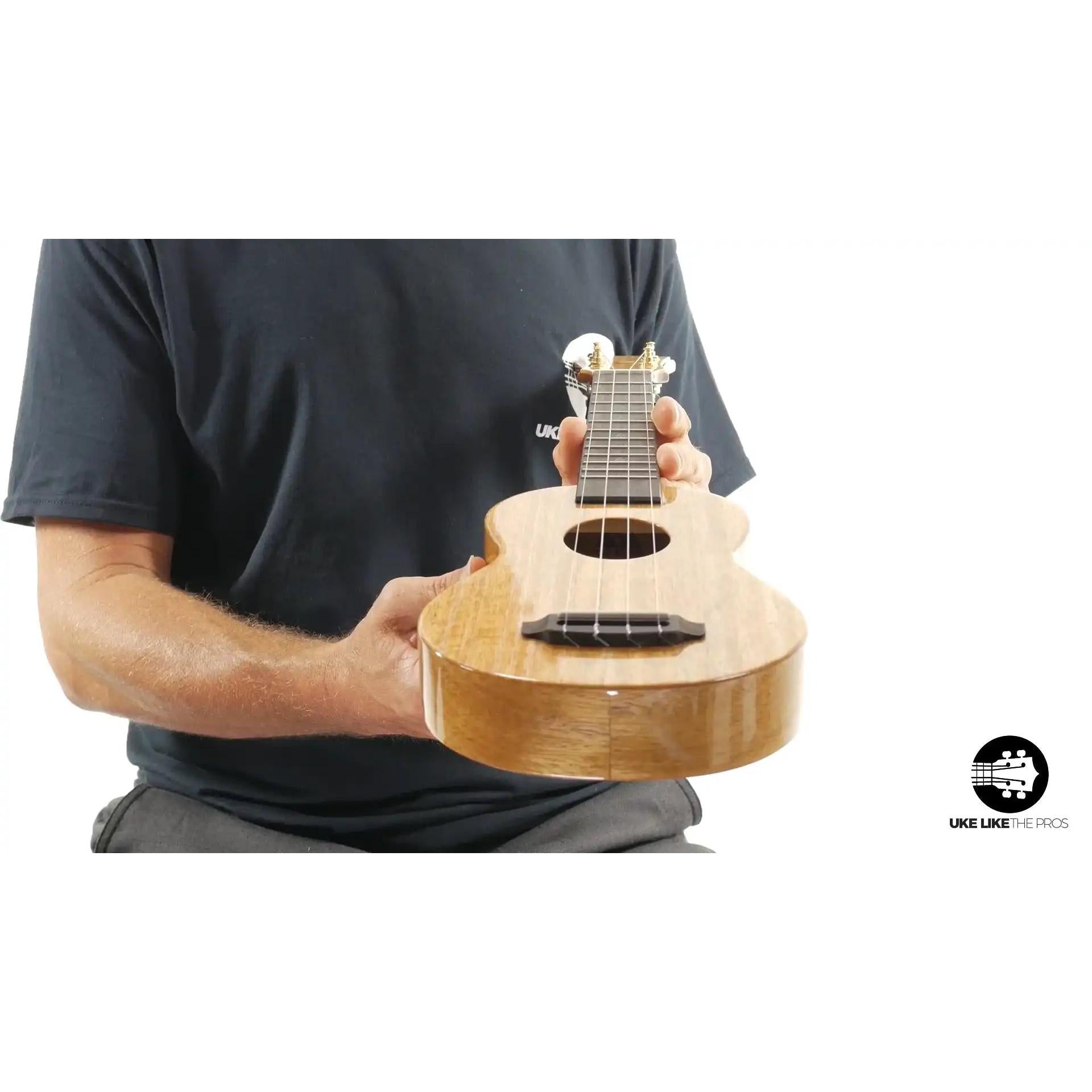 Romero Creations Mini T-Rex ukulele with natural wood finish, showcased at Terry Carter Music Store