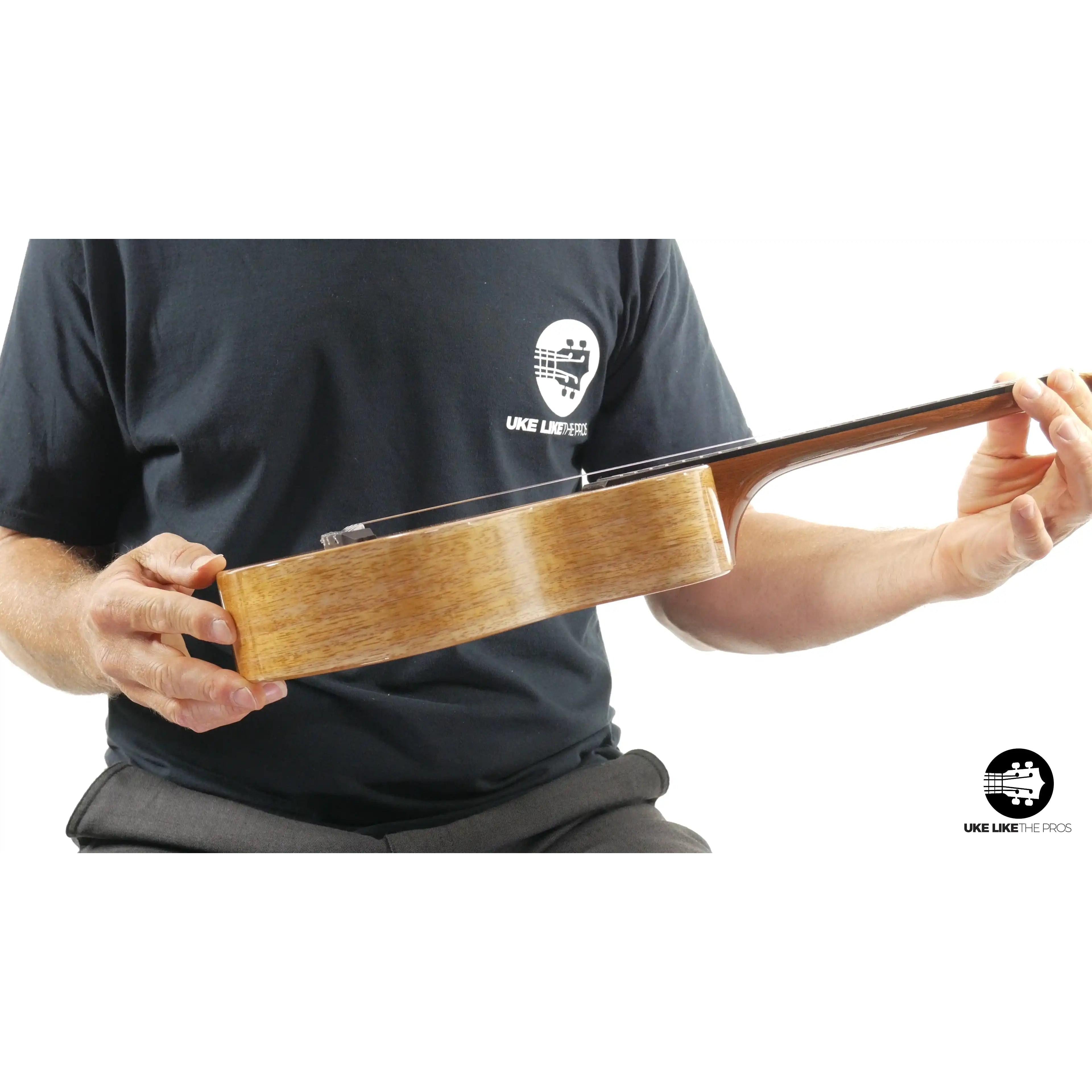 Side view of Romero Creations Rebel Double Creme ukulele with natural wood grain at Terry Carter Music Store.