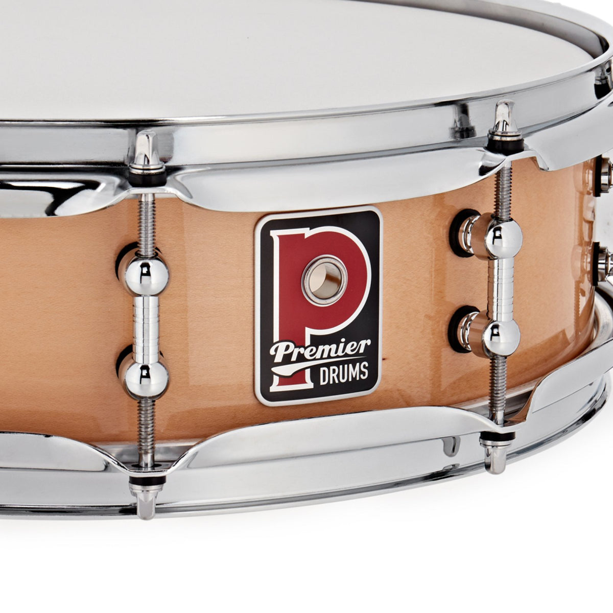 Close-up of the Premier badge and chrome tube lugs on the Premier Beatmaker 14" x 4" maple snare drum