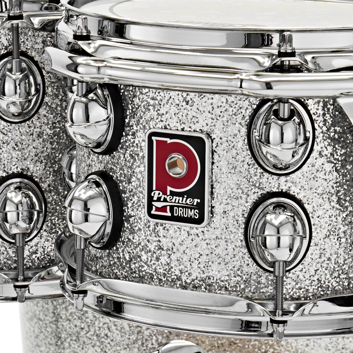 Close-up of the Premier badge, tension lugs and triple-flange hoop on a Silver Sparkle Premier Genista Maple rack tom