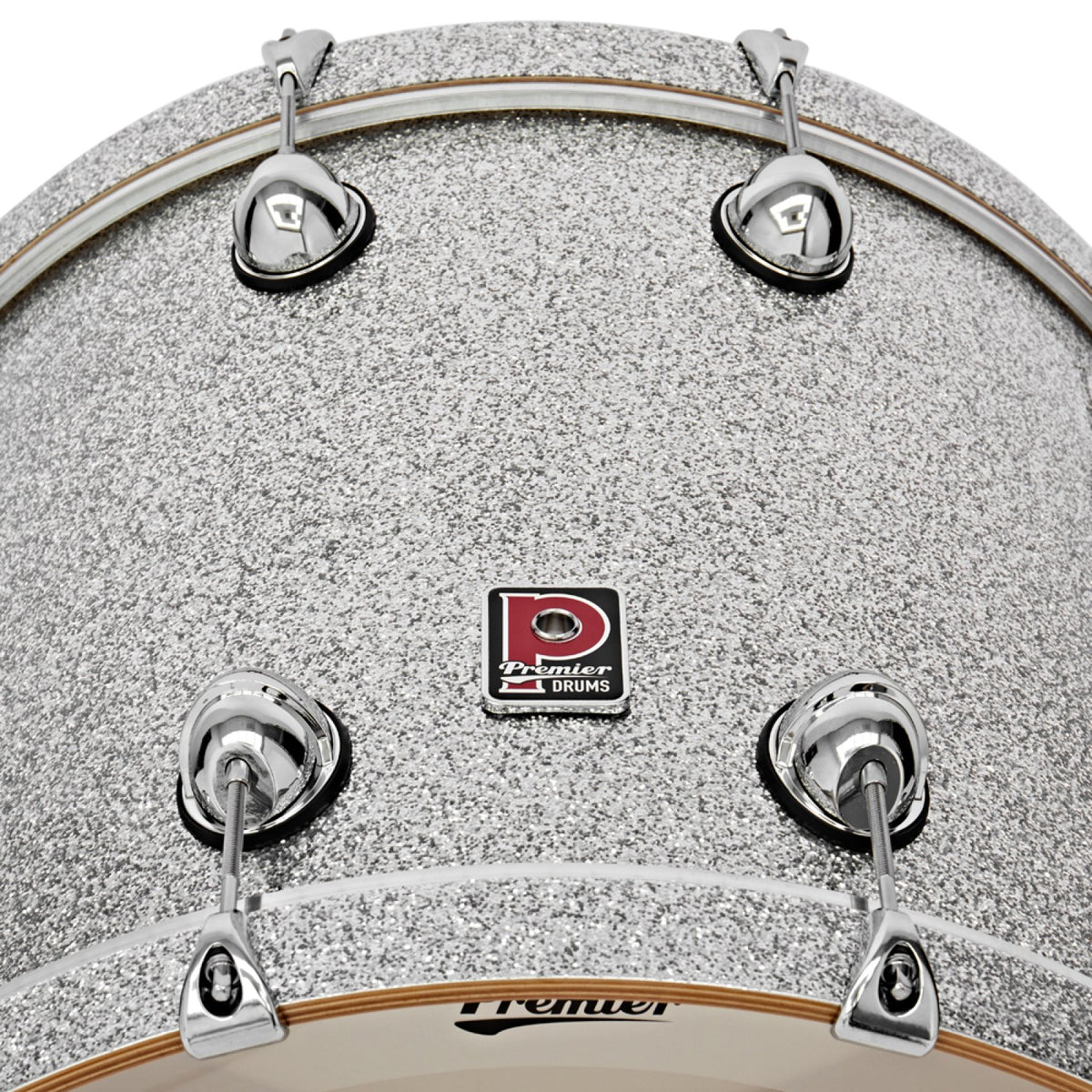 Close-up of the Premier badge and tension lugs on the Silver Sparkle Genista Maple 22 x 18 bass drum