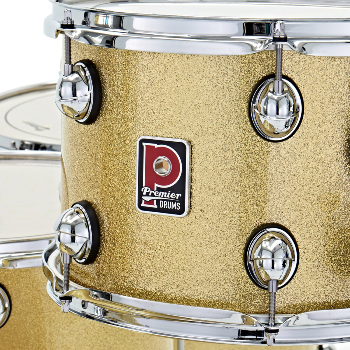 Close-up of the Premier badge, tension lugs and chrome hoop on a Vintage Gold Sparkle Premier Genista Heritage tom