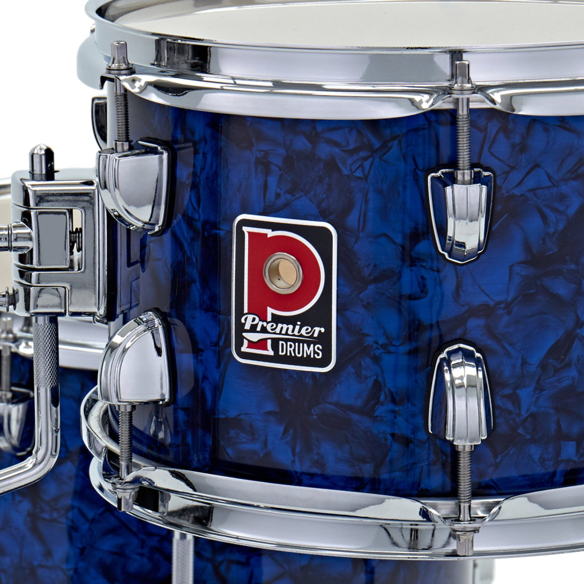 Close-up of the Premier badge and chrome tension lugs on a drum from the Premier Artist Heritage 16-inch 4-piece shell pack in Blue Pearl
