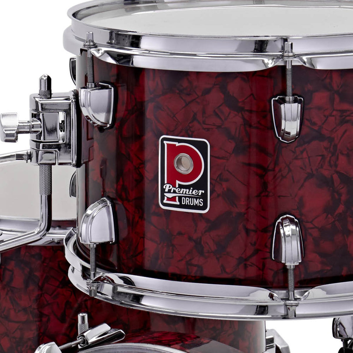 Close-up of the Premier badge and chrome tension lugs on a drum from the Premier Artist Heritage 18-inch 4-piece shell pack in Burgundy Pearl