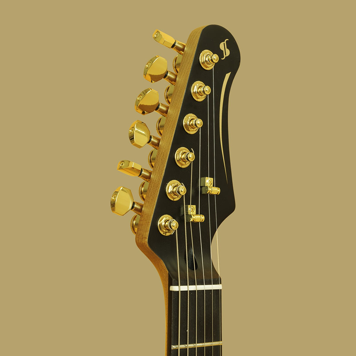 Black headstock with gold locking machine heads and Stagg logo on the Stagg 30th Anniversary Legacy guitar