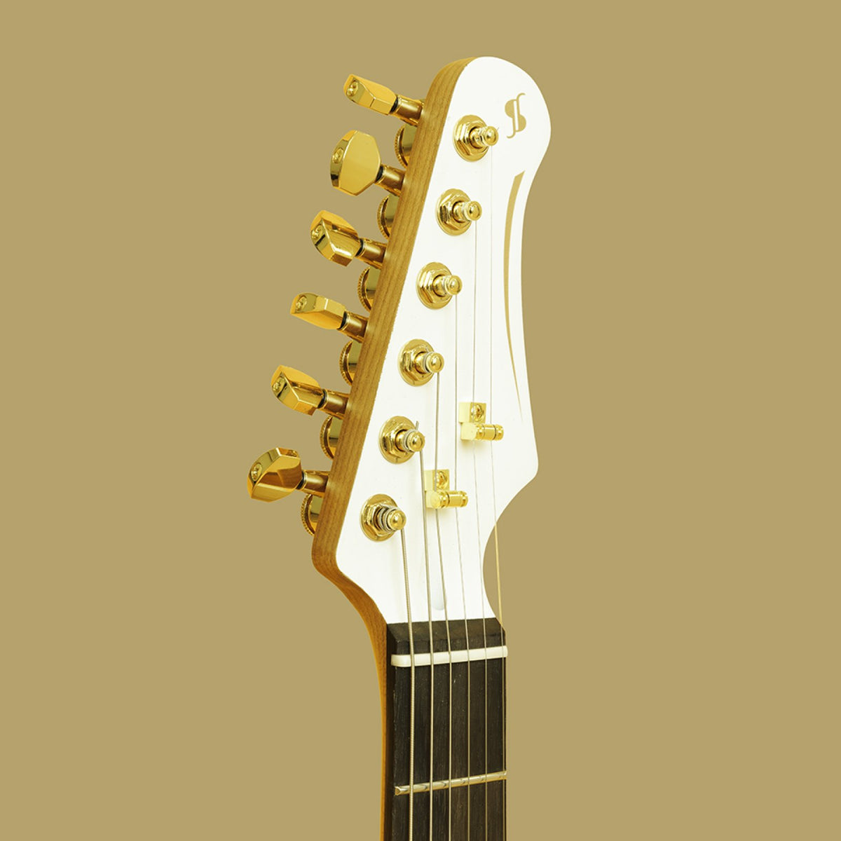 White headstock with gold locking machine heads and Stagg logo on the Stagg 30th Anniversary Legacy guitar