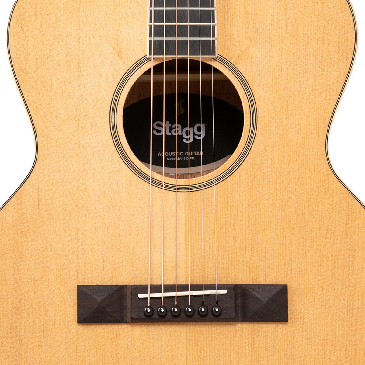 Close-up of the spruce top, soundhole rosette and rosewood bridge on the Stagg SA45 O-FM guitar