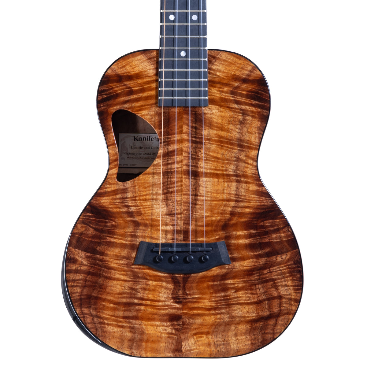 Upper bout of Kanile'a DK-T Pro tenor ukulele serial 30299 showing the koa top grain and the label inside the soundhole