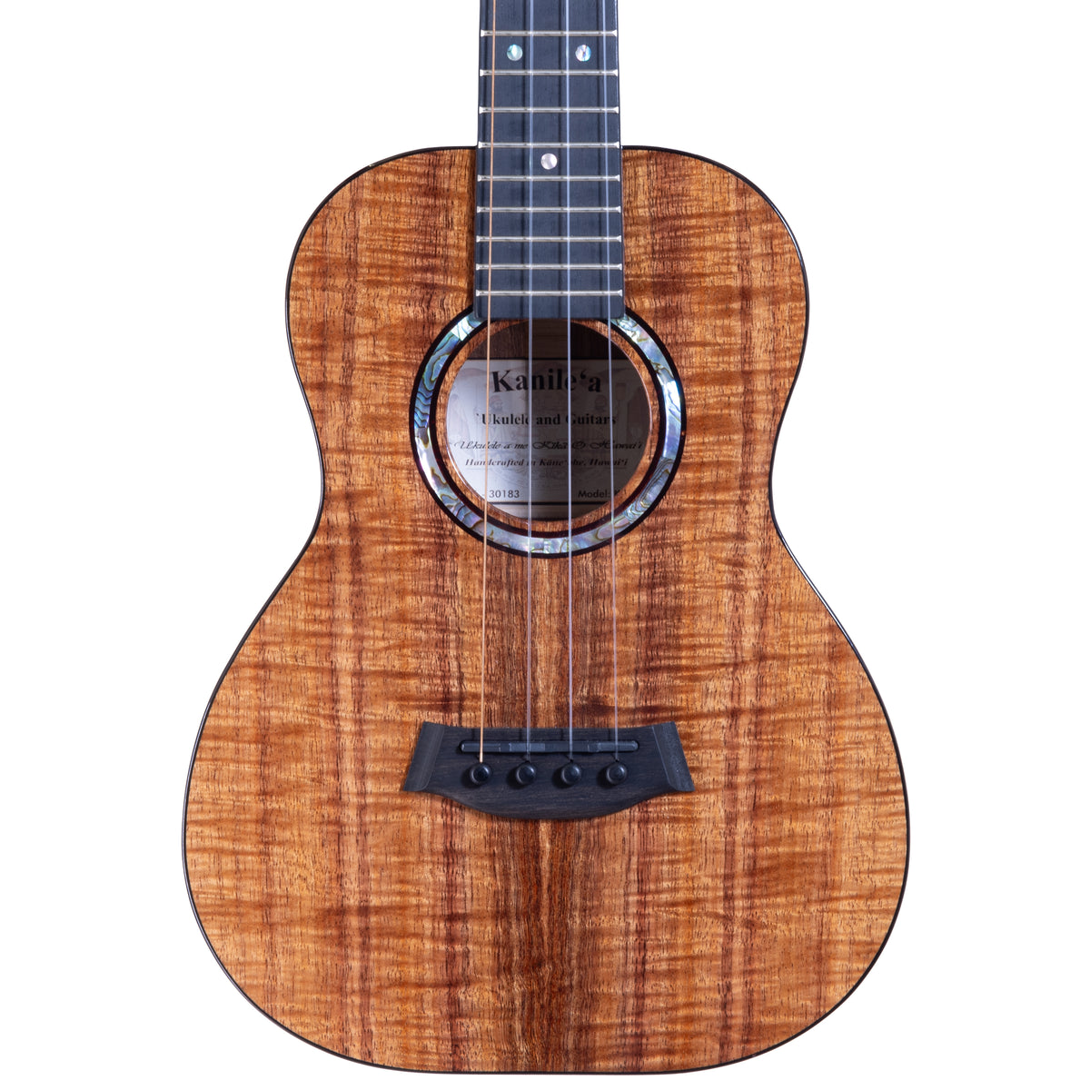 Upper bout of Kanile'a KPA-T Pro tenor ukulele serial 30183 showing the koa top grain and the label inside the soundhole