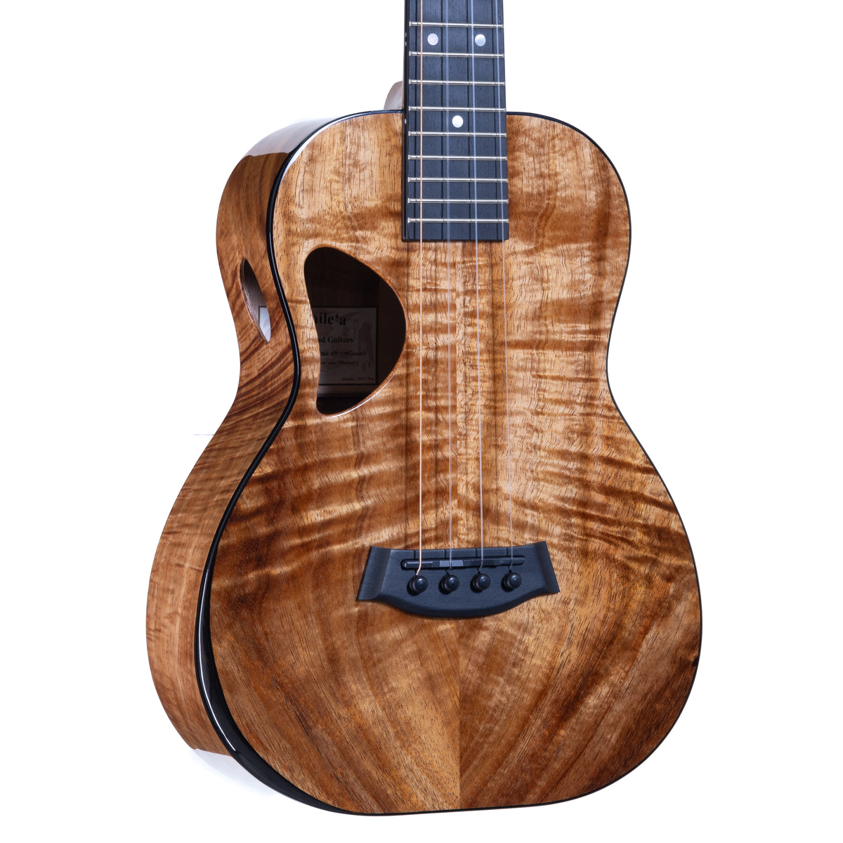 Close-up of the figured koa top, ebony bridge and D-shaped soundhole with oval side sound port on Kanile'a DK-T Pro tenor ukulele, serial 30180