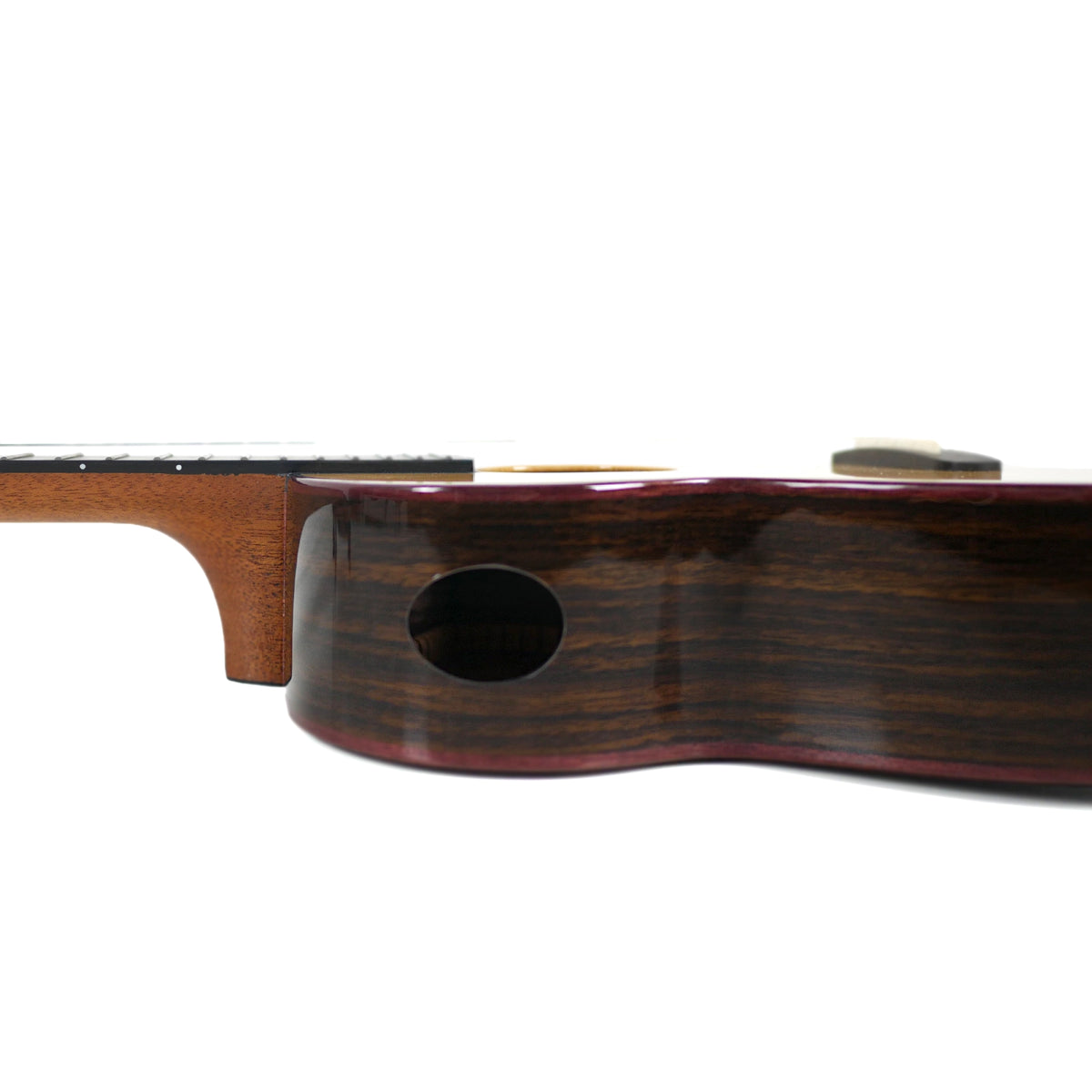 This side view of the Kala CTD-SSRW-TG-C Tenor Ukulele highlights its solid rosewood sides and side sound port.