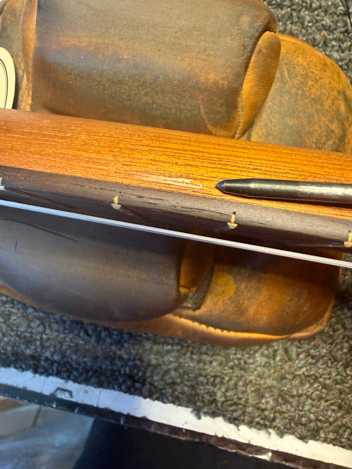 Close-up of the small wood chip on the underside of the neck of this Kala JT-T-CE tenor ukulele