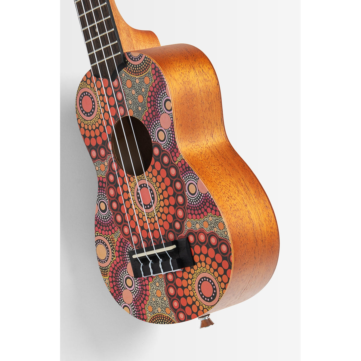 Angled view of the Kala KA-DS-CM-SC-S showing the artwork top and mahogany sides