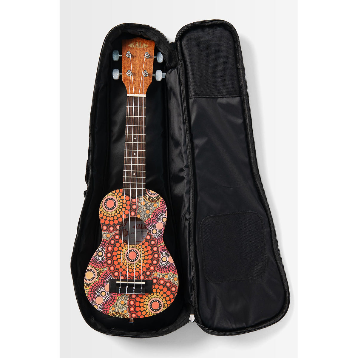 Kala KA-DS-CM-SC-S resting on its black Desert Storylines gig bag