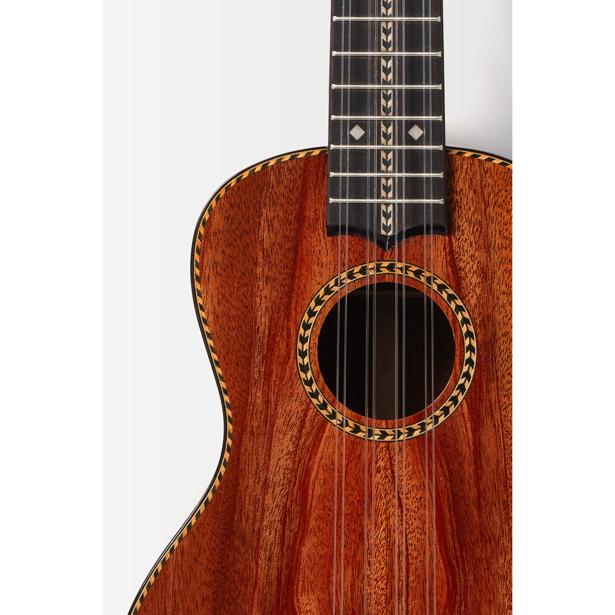 Kala KA-TARO-ASMH-C body front close-up, solid mahogany top with herringbone rosette and rosewood bridge