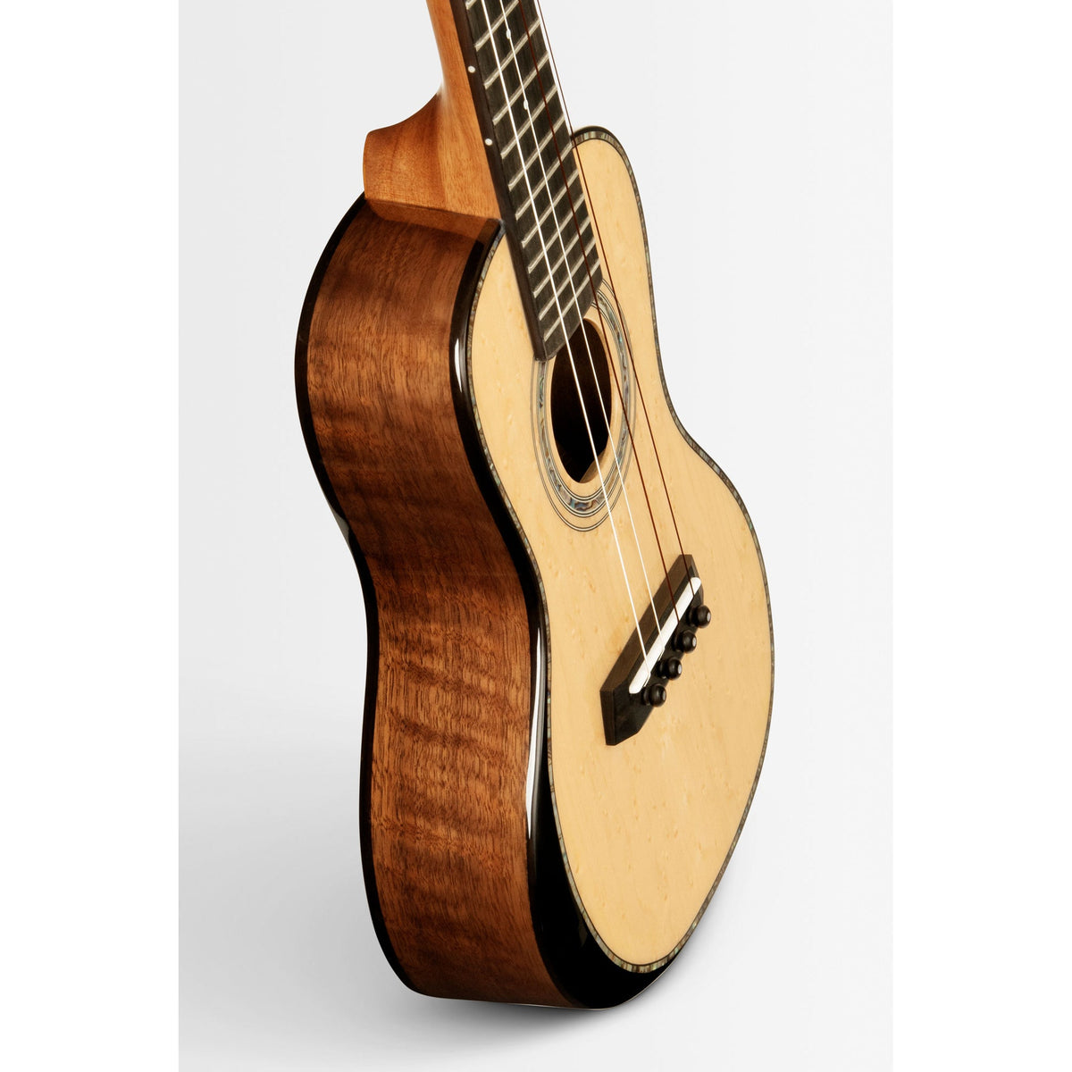 Angled view of the Kala KA-WCW-BMP-C showing the gloss walnut sides and mahogany comfort edge