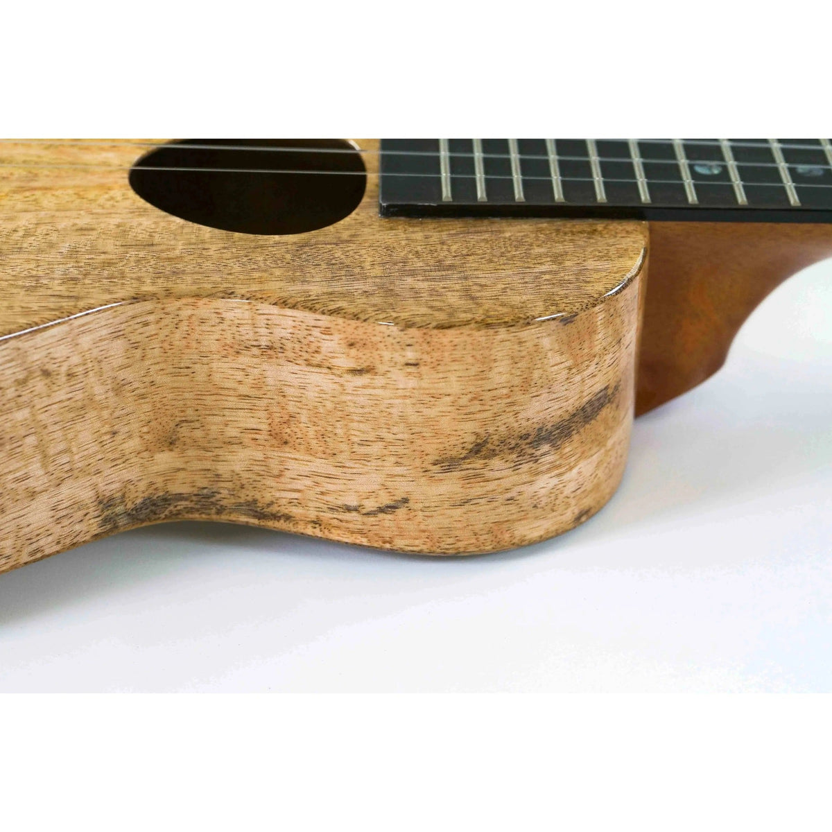 Example photo: side view of an earlier KoAloha KCM-00MG gloss solid mango concert ukulele