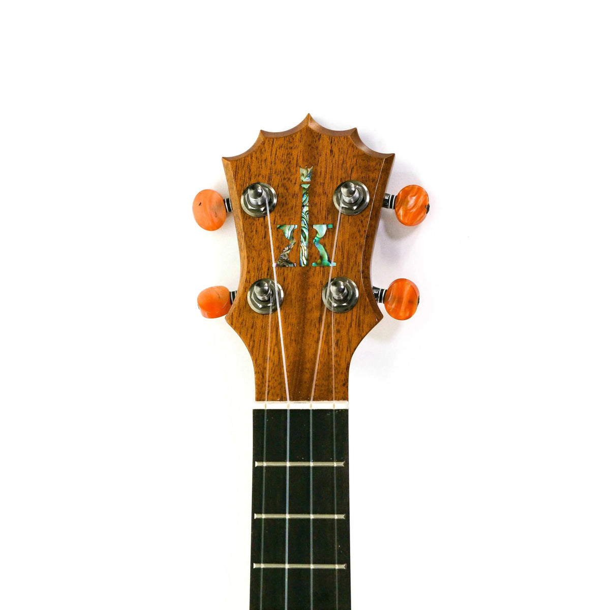 Example photo: front of the 5-pointed crown headstock of a KoAloha KCNP-00, the gloss version of the KCNP-10 Naupaka concert in koa and mango