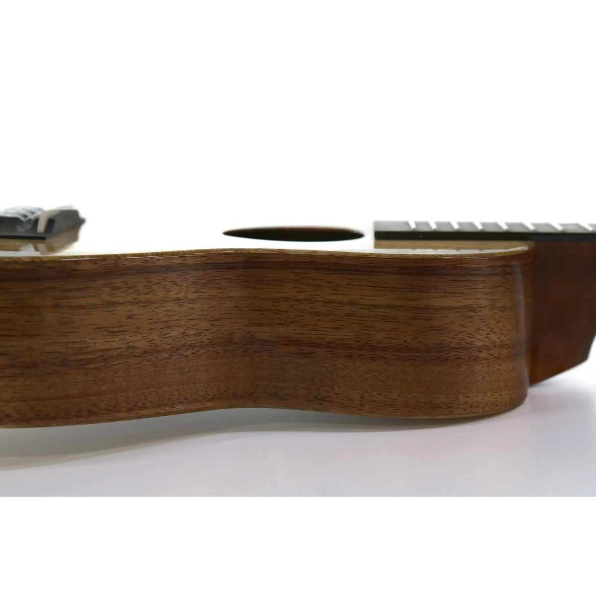 Example photo: side view of a KoAloha KCNP-00 Naupaka concert ukulele in koa and mango, a larger size than the KSNP-00 soprano