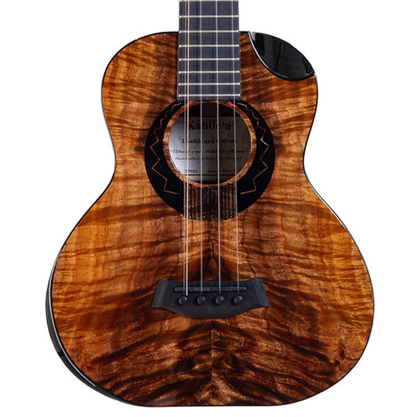A close-up of a Kanile'a Willie`K 5-String Super Tenor Ukulele front showing a rich, curly figured top wood finish in warm brown and amber tones, with black hardware and rosette details on a white background.
