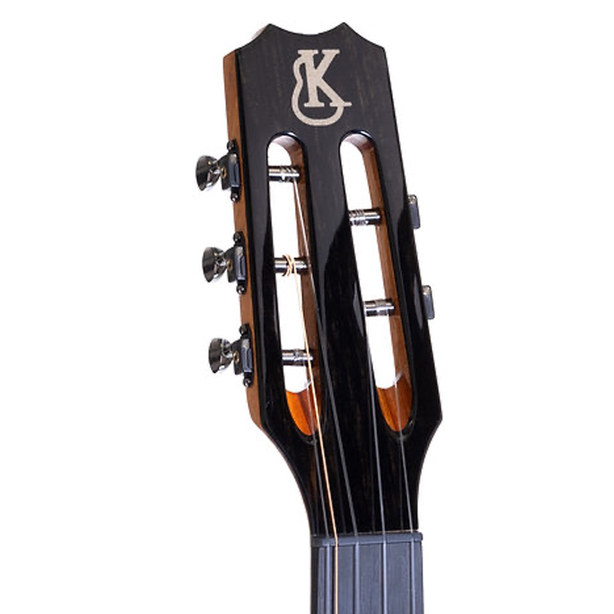 Close-up of the headstock of a uke, showing the dark glossy finish, four tuning pegs, sound holes, and a stylized 'K' logo on a white background.