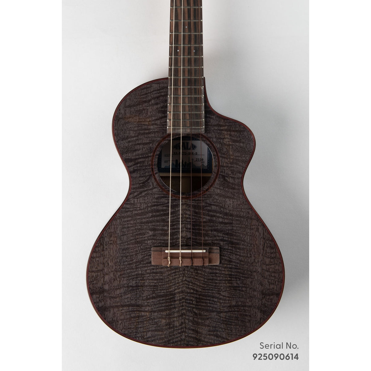 Kala METD-BMR-B Metropolitan Deluxe baritone ukulele, serial 925090614, front view showing the solid mango top's dark figured grain and ebony rosette with red purfling