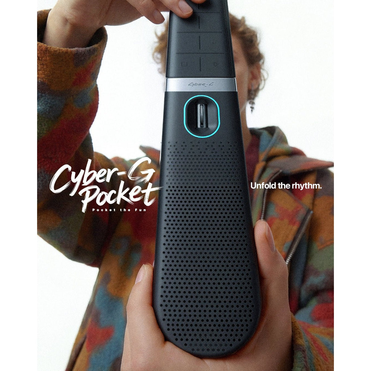 Player holding the Enya Cyber-G Pocket in Black, speaker grille facing the camera