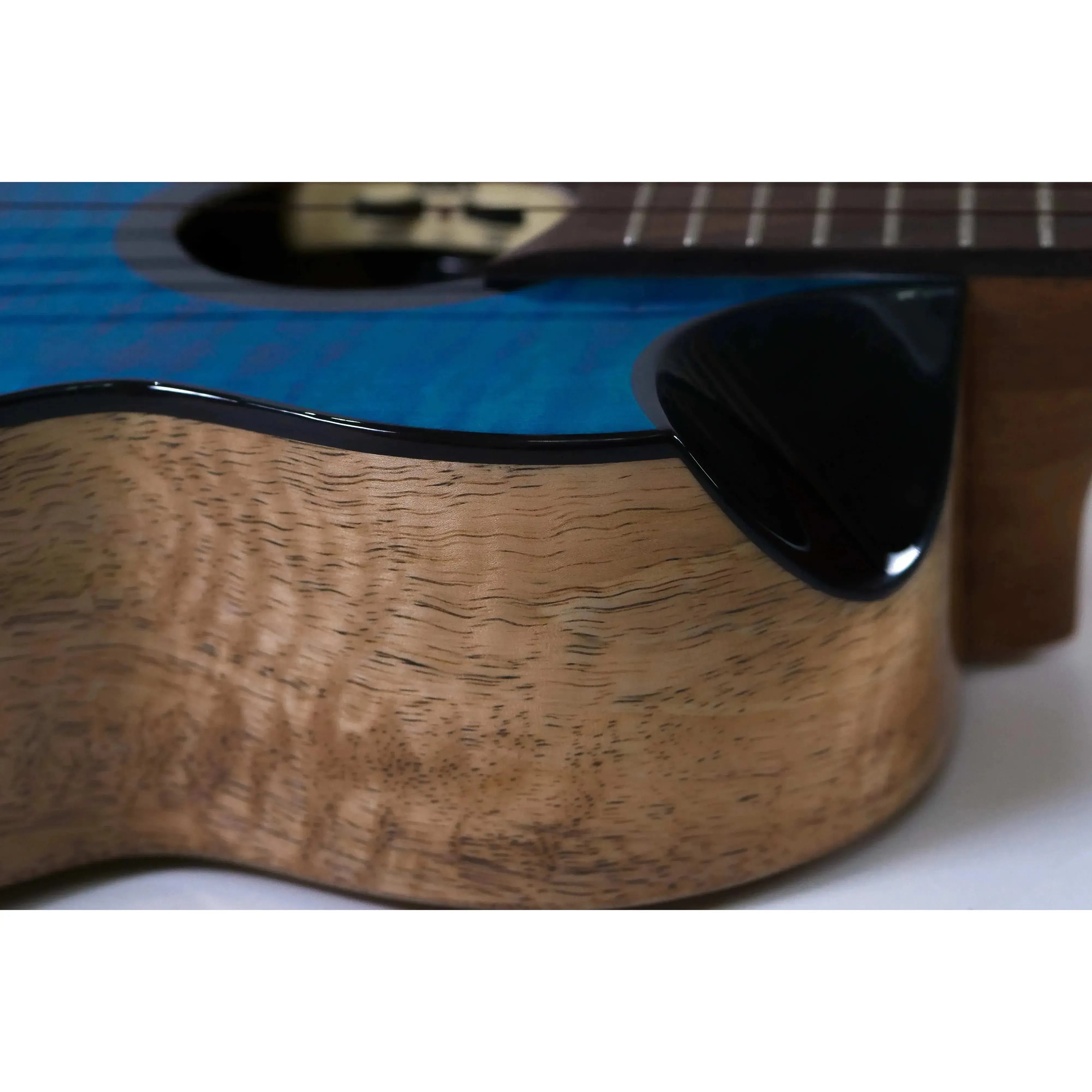 Flight Comet Blue EQ-A Tenor Ukulele, showing its blue flamed maple top and natural mango wood sides.