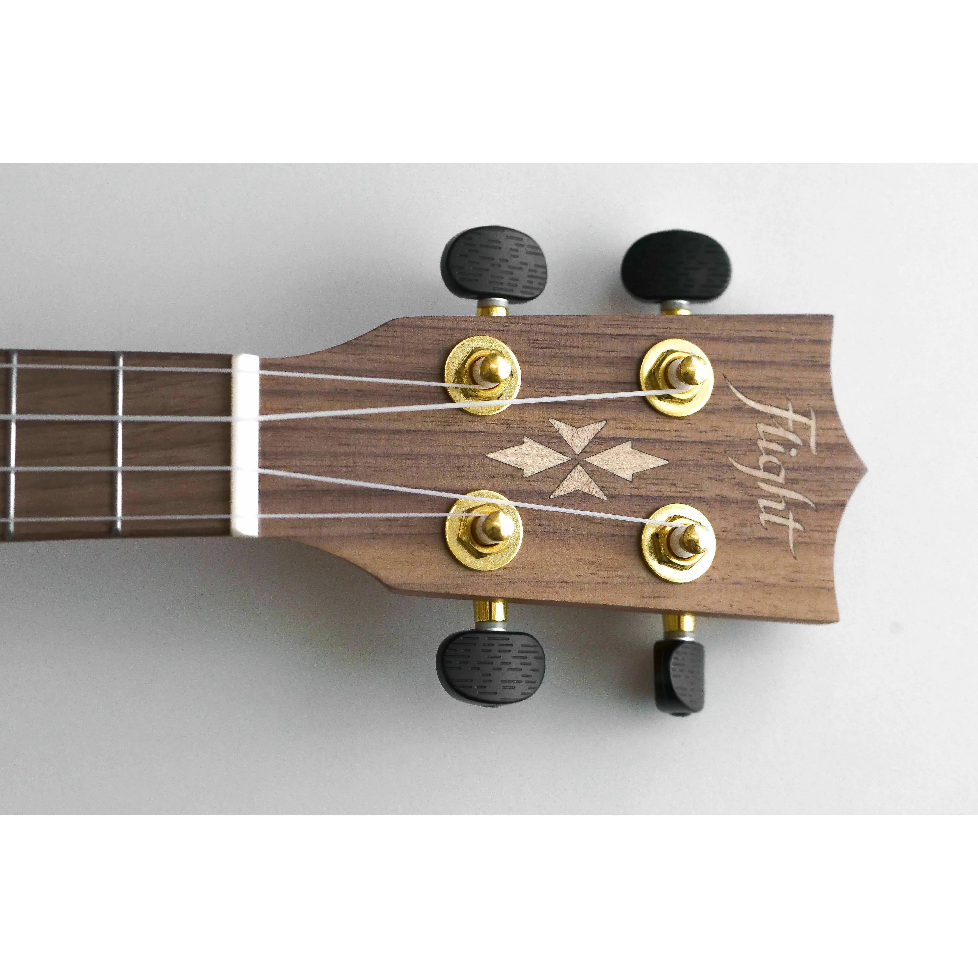 Flight DUC430 Dao Concert Ukulele headstock with gold tuners, black knobs, and a light wood inlay.